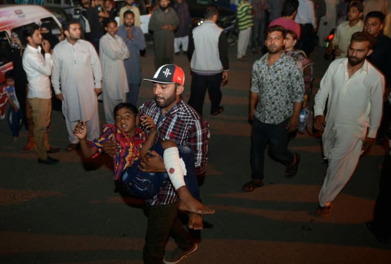 Un jeune pakistanais blessé transporté par un proche vers un hôpital après une explosion meurtrière à Lahore (est), le 27 mars 2016 . © AFP